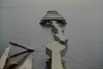Looking down damaged long concrete pier